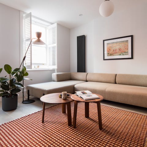 Relax in the bright, open-plan living room with a classic look and style