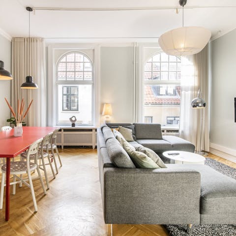 Peer out onto the bustle of Strøget below through the dual-aspect windows