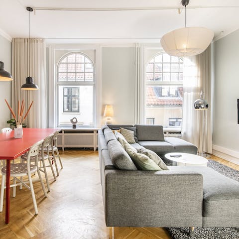 Peer out onto the bustle of Strøget below through the dual-aspect windows