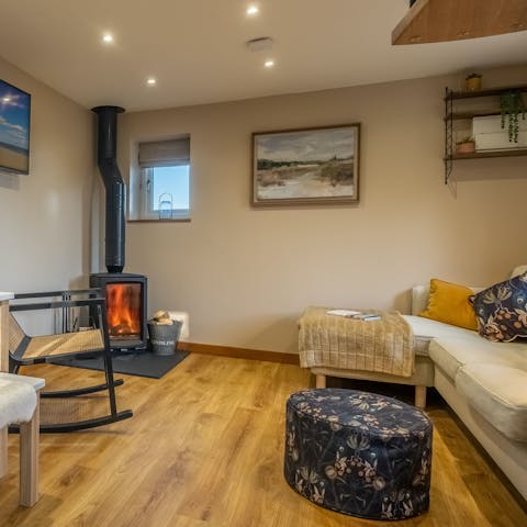 Get cosy by the warmth of the wood-burning stove