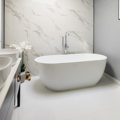 Treat yourself to a long soak in the freestanding bath tub