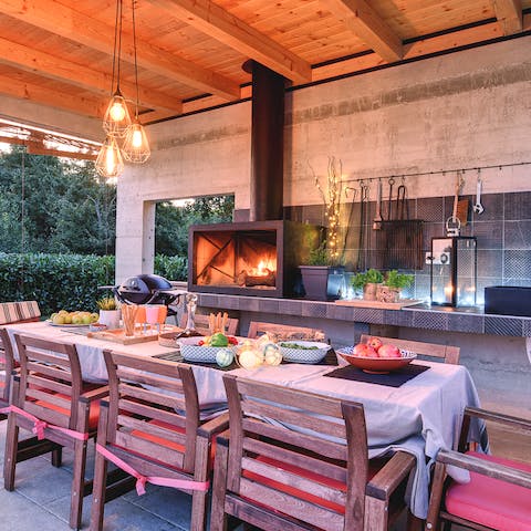 Feast on Croatian delicacies at the alfresco dining table and outdoor kitchen