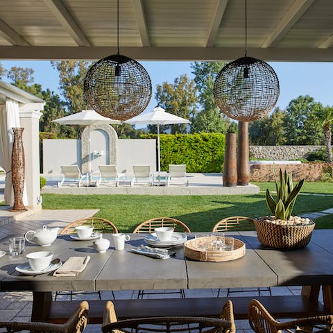 Tuck into alfresco feasts beneath the pergola