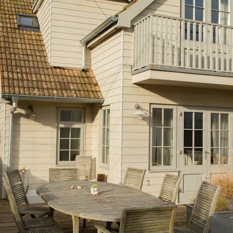 End the day with drinks on the porch, overlooking the sand dunes