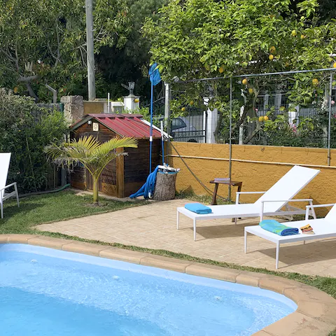 Cool off in the inviting pool and relax on the sunbeds in the shade of the fruit trees