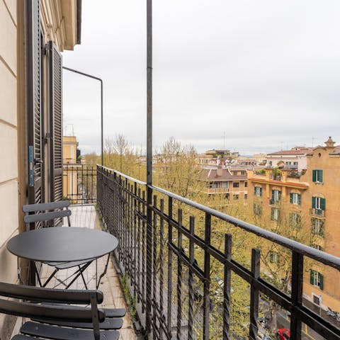 Take in the Roman rooftop views from the private balcony