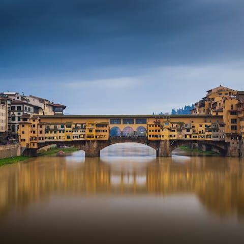 Traverse the picturesque Ponte Vecchio, 150 metres away