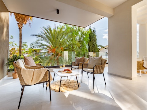 Sip wine among palms on the sun-caught terrace