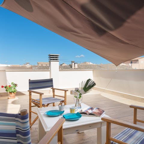 Share an aperitif of Spanish wine on the rooftop terrace