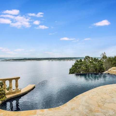 Admire the views over the lake from the infinity pool