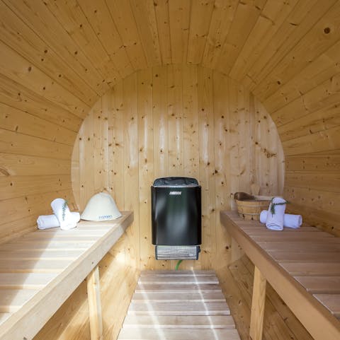 Decompress at the end of a long day in the cosy barrel sauna