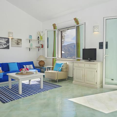 Enjoy time in the breezy living room with a view of the landscape