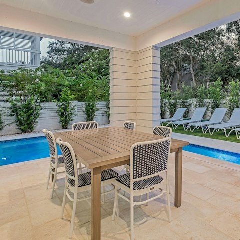 Tuck into something tasty at the table after a dip in the pool