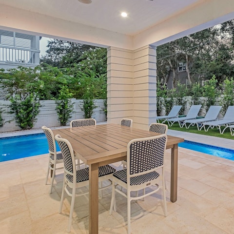 Tuck into something tasty at the table after a dip in the pool