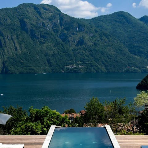 Admire the beautiful views of the lake and mountains from the infinity pool