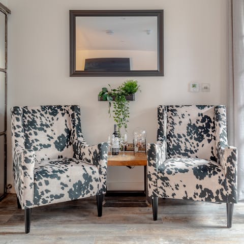 Unwind with a good book on the chic animal print armchairs