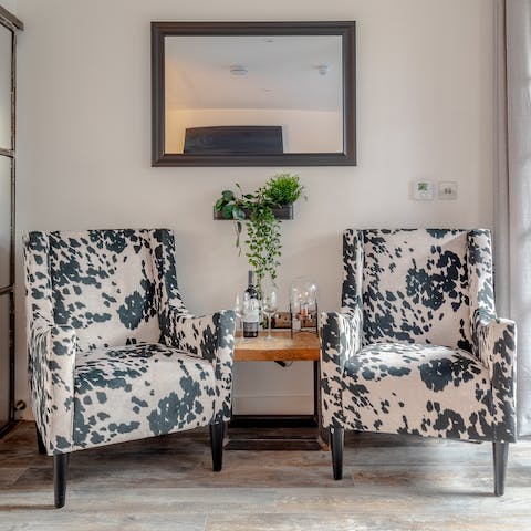 Unwind with a good book on the chic animal print armchairs