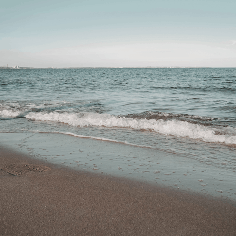 Spend an afternoon on Platis Gialos Beach, a twelve-minute walk away