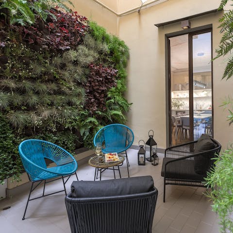 Take holiday selfies in front of the vertical garden as you enjoy some wine