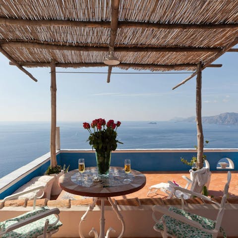 Sip wine on the terrace as you drink in the sea views