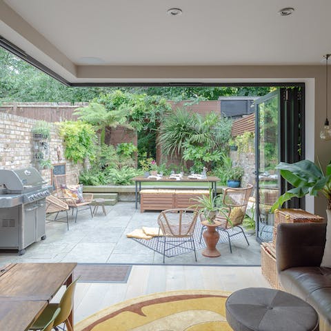 Throw open the bespoke folding doors for seamless indoor-outdoor living