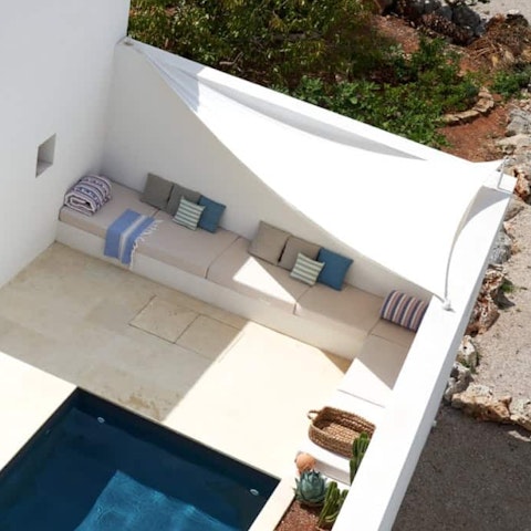 Lounge with a good book next to the crystal-clear pool