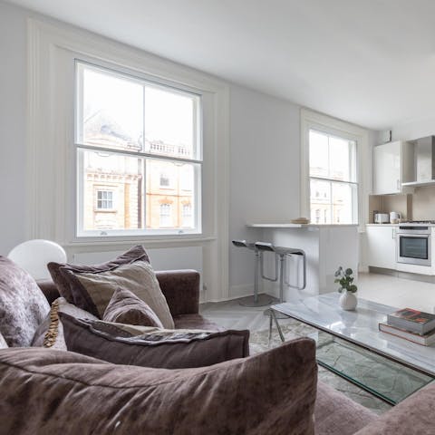 Get cosy in the sleek living area and rest feet tired from sightseeing