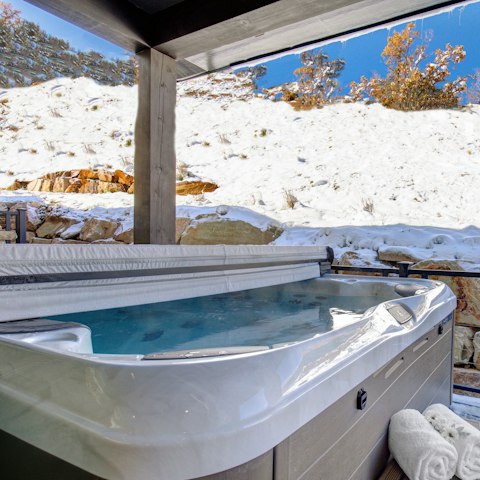 Watch dusk fall from the bubbles of the hot tub after a day spent skiing