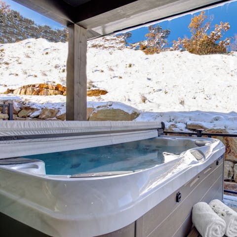 Watch dusk fall from the bubbles of the hot tub after a day spent skiing
