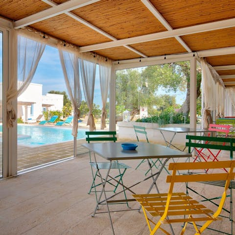 Take a moment in the shade on the colourful bistro chairs, playing cards and enjoying the view