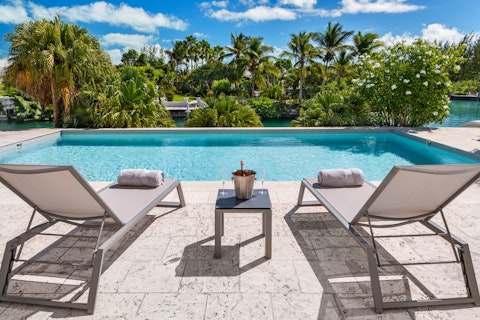 Stretch out beside the pool with champagne on ice