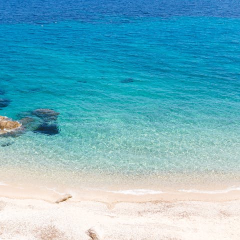 Head down to Psarou Beach for a day of sun, sand, and sea after a six-minute walk from home