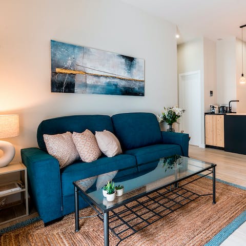 Relax on the plush sofa, sipping on a glass of wine, and watching the smart TV after a day of exploring