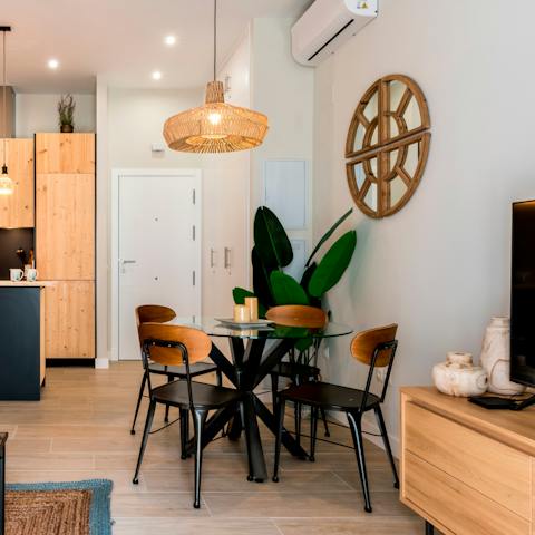 Gather around the chic, sleek dining table for relaxed dinners, drinks, and card games at home