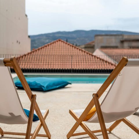 Wile away the day by the communal pool