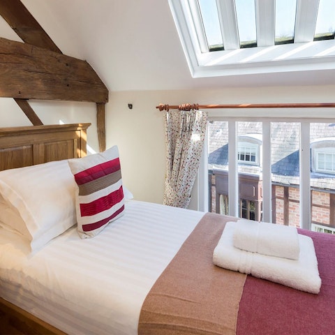 Wake up in the bright bedroom below the striking skylights