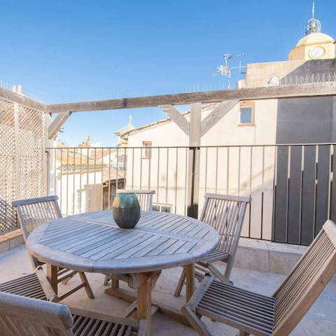 Dine alfresco on the terrace, with a view of the rooftops