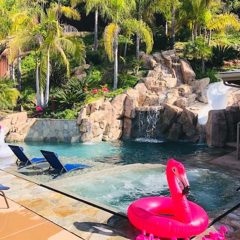 Shelter under the waterfall or hop on a pink flamingo in the pool