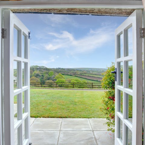 Open the living room's French doors for unparalleled views of the surrounding rolling hills