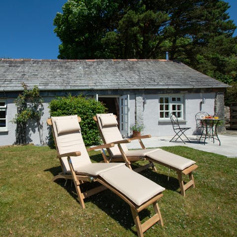 Sun yourself on the garden's loungers while taking in views of the Cornish countryside
