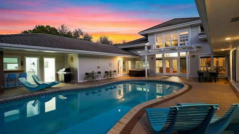 Cool off in the pool as dusk settles over the estate