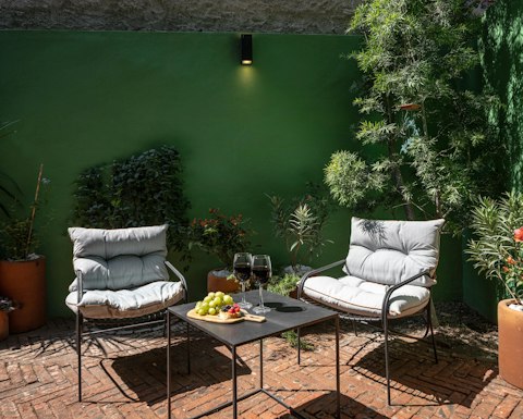 Linger over a glass of wine in the sun-filled courtyard