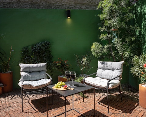 Linger over a glass of wine in the sun-filled courtyard