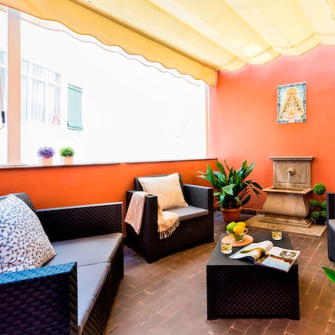 Relax into your rattan furniture on your balcony, listening to the water feature