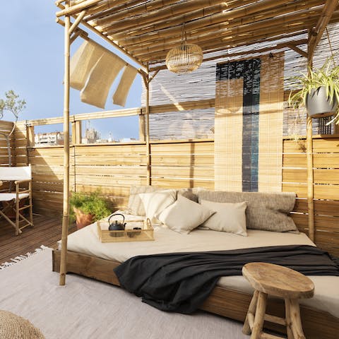 Chill out on your balcony's outdoor daybed while catching some Spanish rays