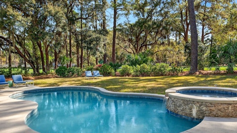 Swim beneath moss-draped oaks with golf course views beyond