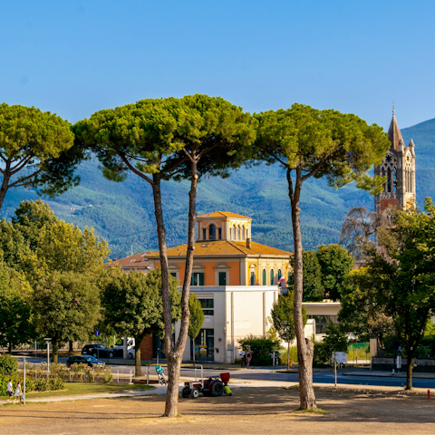 Stroll through Lucca’s charming streets and mountain views