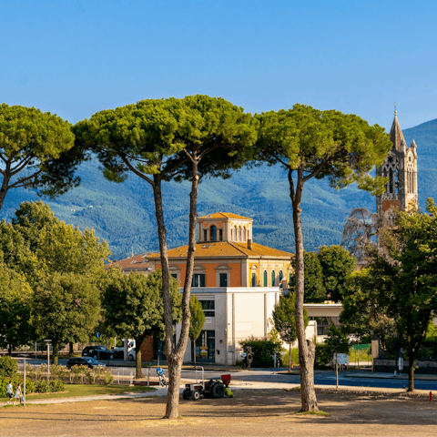 Stroll through Lucca’s charming streets and mountain views