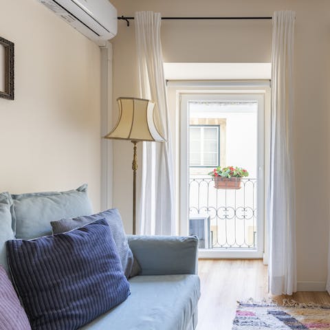 Enjoy the breeze coming through the balcony's door while you sip a glass of wine on the sofa