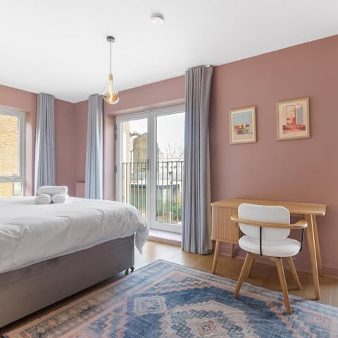 Catch up on work from the serene sanctuary of the main bedroom
